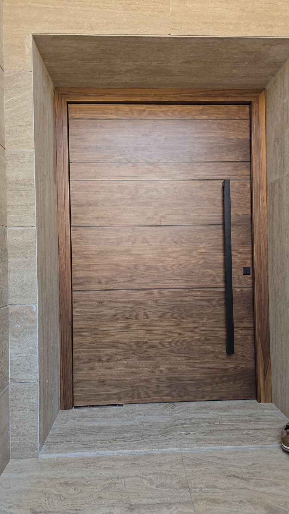 Walnut Grooved Pivot Door With Black Pull